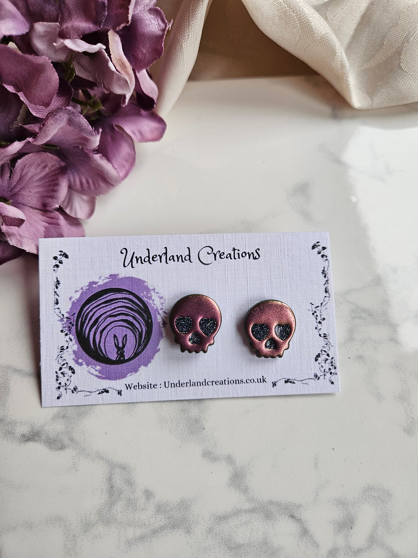 Skull Stud Earrings in Metallic Pink/Gold